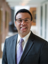 Headshot of Wendell Pritchett, wearing a suit and tie