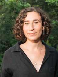 Headshot of Rachel Bondra, smiling with a dark shirt